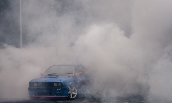 Blue BMW with White Smoke Coming from It