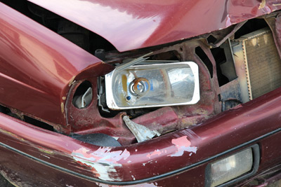 Damaged Car Not Worth Repairing Showing Headlight, Hood and Bumper
