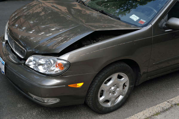 silver car with damaged front hood