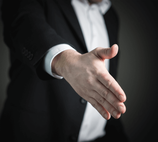 car salesman making a deal with a handshake