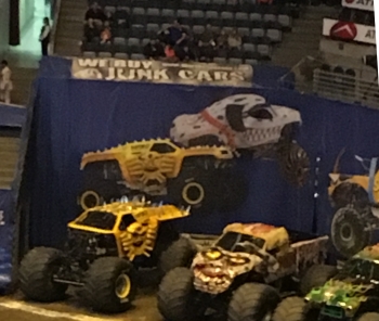 We Buy Junk Cars Sign at Milwaukee Monster Jam above Trucks