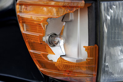 Smashed Car Headlight Needing Used Replacement from Salvage Yard